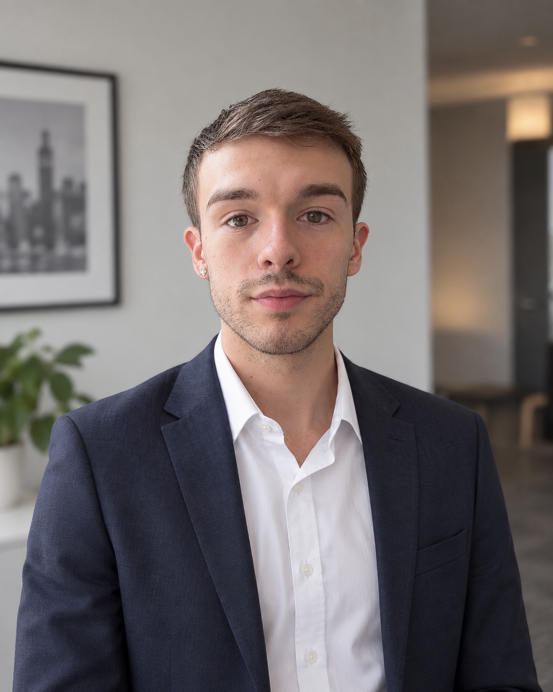 Professional headshot of Erich Lipner wearing a navy blazer and white shirt